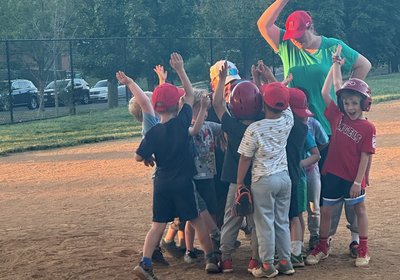 Coaches celebrating with Tee Ball players